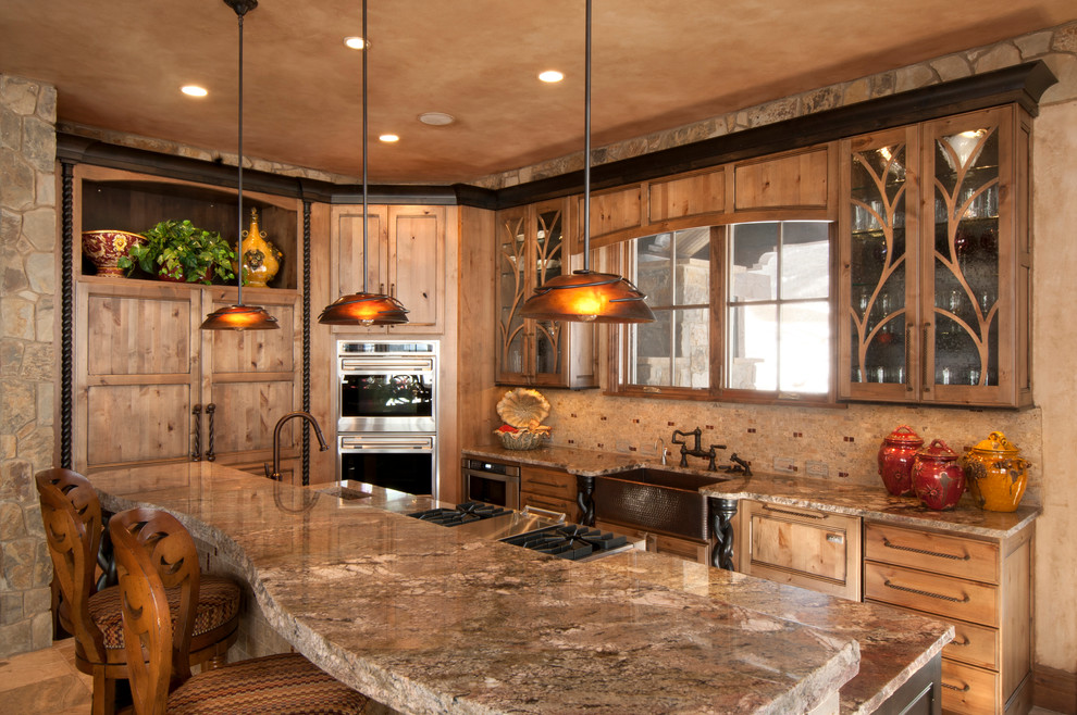 This is an example of a mid-sized traditional l-shaped eat-in kitchen in Denver with an undermount sink, recessed-panel cabinets, medium wood cabinets, granite benchtops, beige splashback, stainless steel appliances and with island.