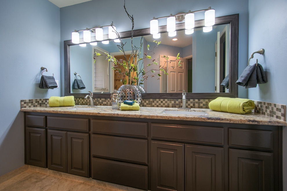 This is an example of a mid-sized transitional 3/4 bathroom in Portland with raised-panel cabinets, grey cabinets, granite benchtops, multi-coloured tile, glass tile and blue walls.