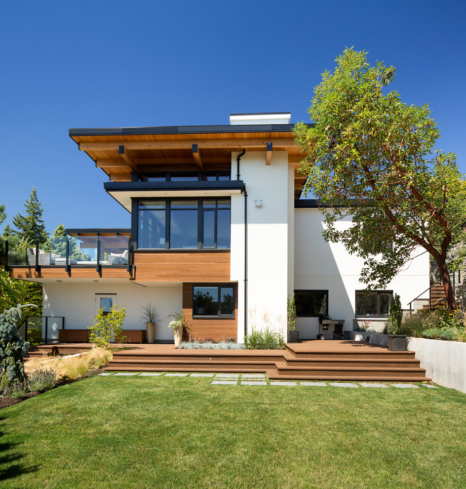 Design ideas for a contemporary two-storey white exterior in Vancouver.