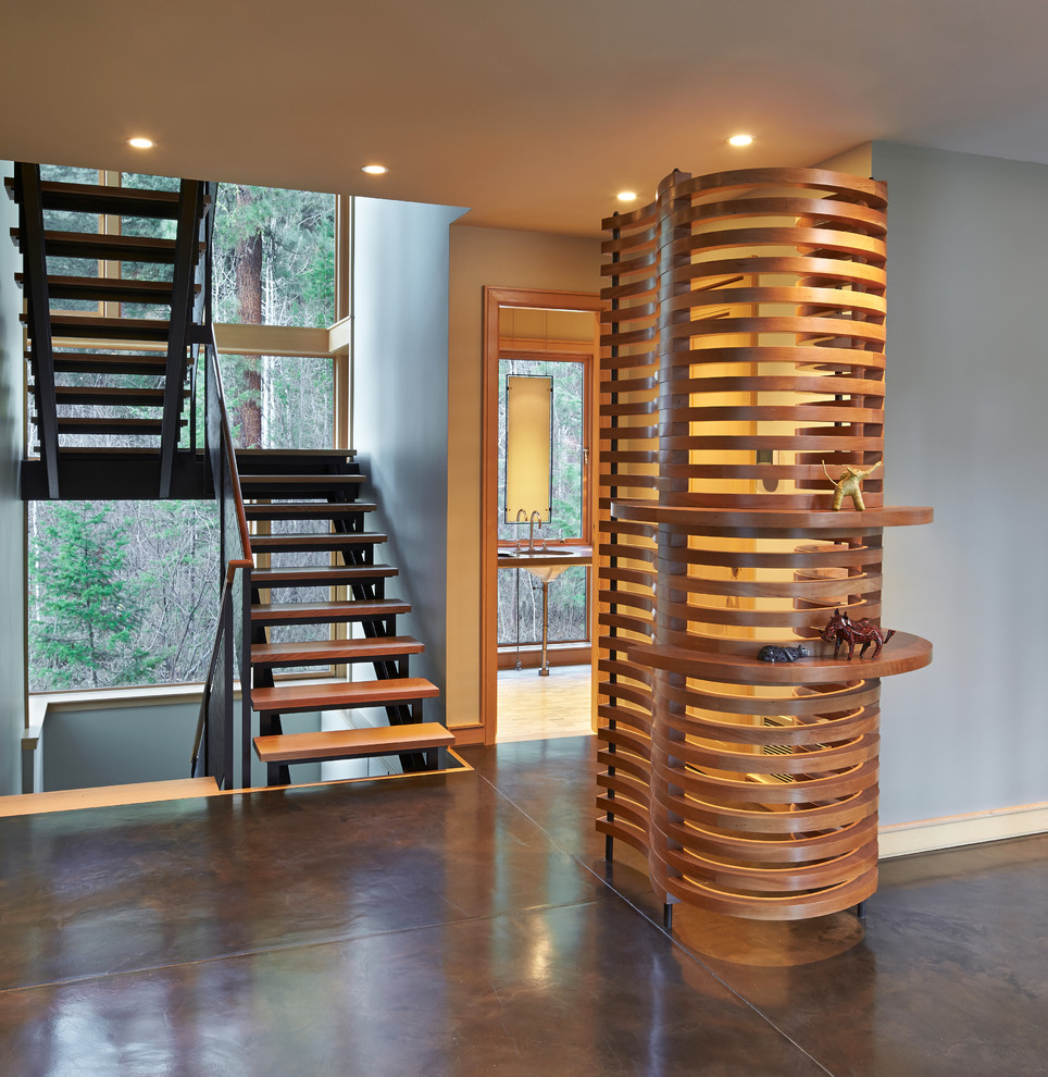 This is an example of a large contemporary wood u-shaped staircase in Seattle with open risers.