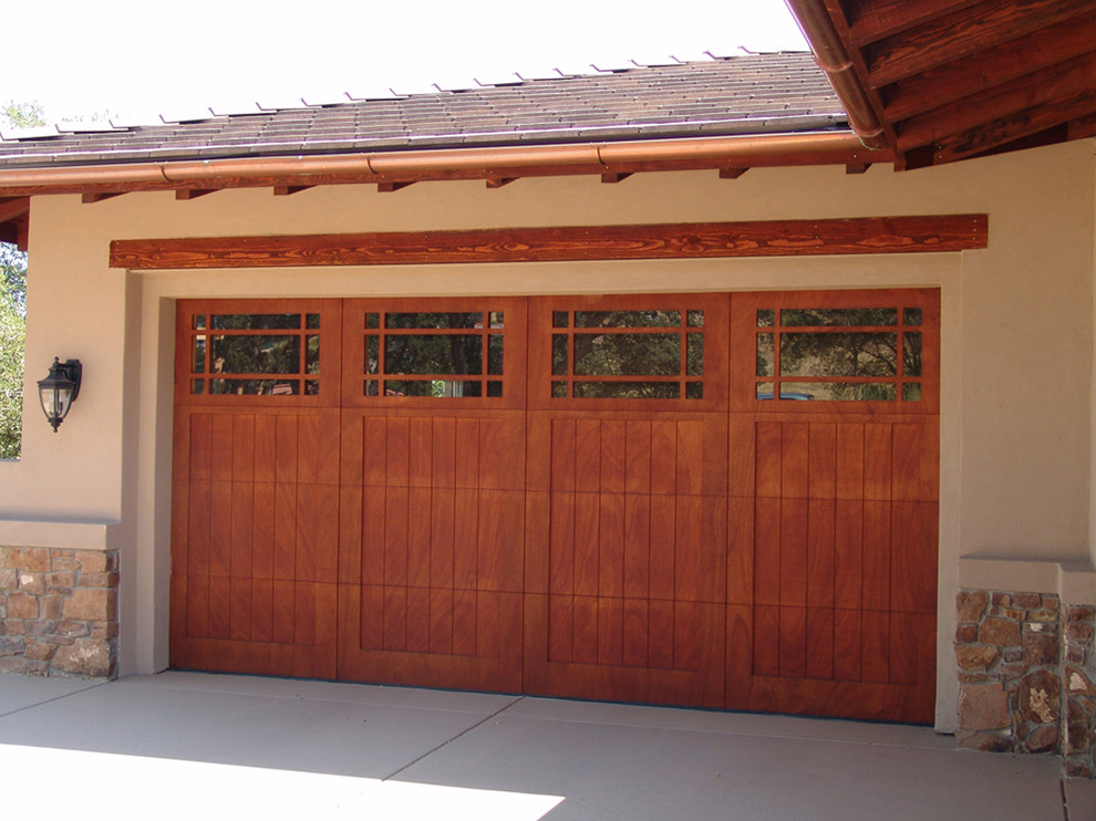 This is an example of a mid-sized arts and crafts attached two-car garage in Los Angeles.