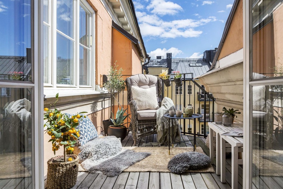 Scandinavian balcony in Stockholm with metal railing and no cover.