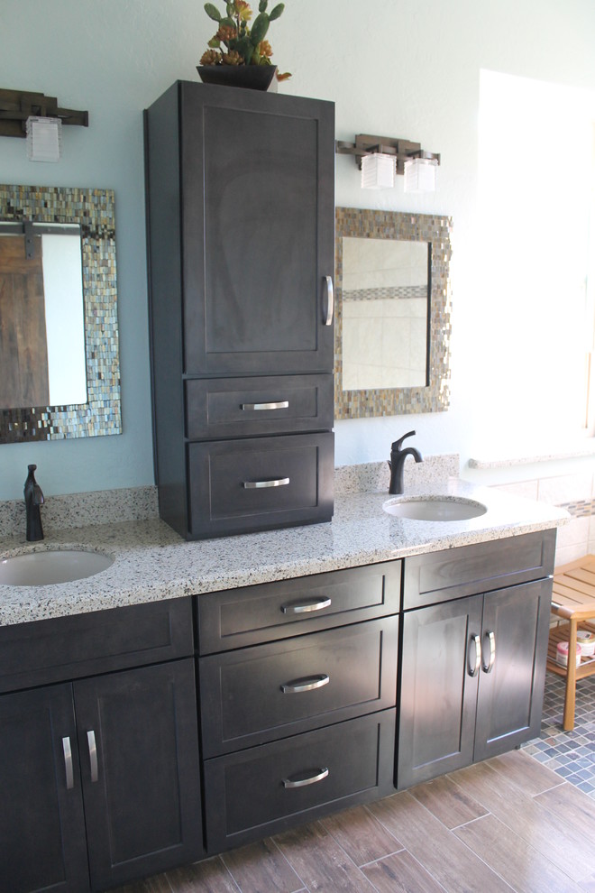 Example of a mid-sized transitional master beige tile and porcelain tile porcelain tile and brown floor walk-in shower design in Phoenix with flat-panel cabinets, black cabinets, a two-piece toilet, blue walls, an undermount sink and quartz countertops