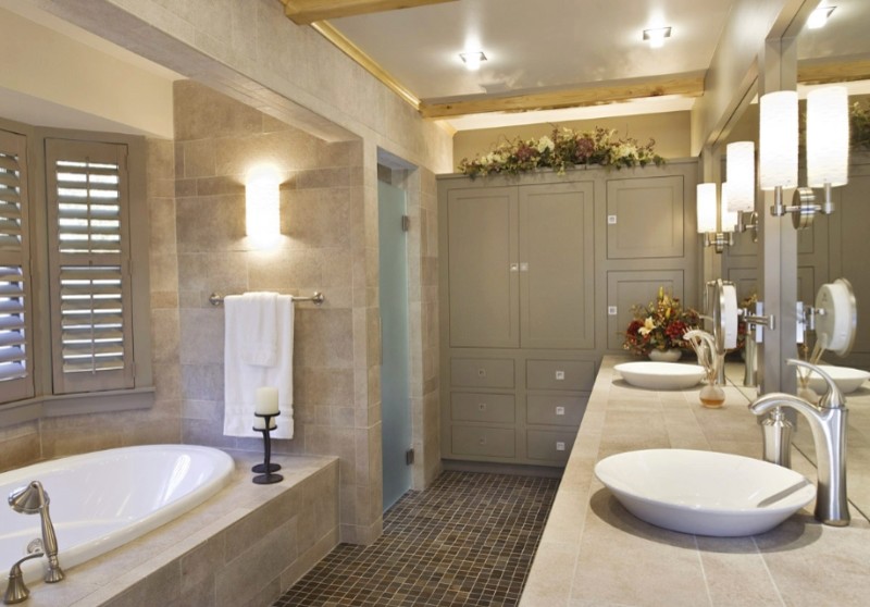 This is an example of a large modern master bathroom in New York with a vessel sink, flat-panel cabinets and a drop-in tub.