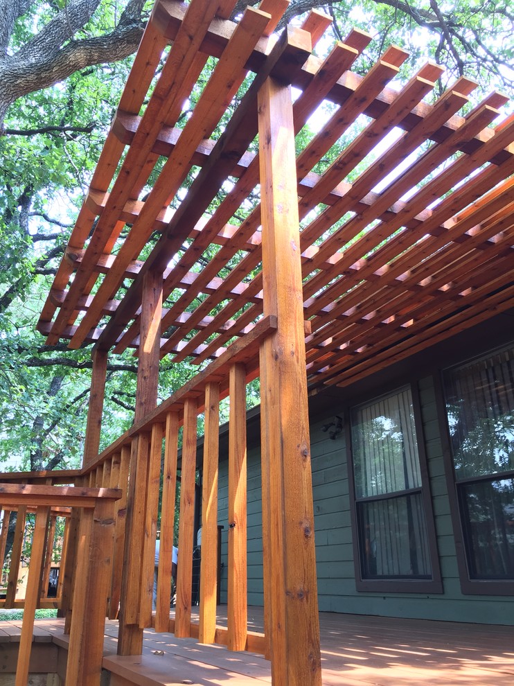 Mid-sized arts and crafts backyard deck in Dallas with a pergola.
