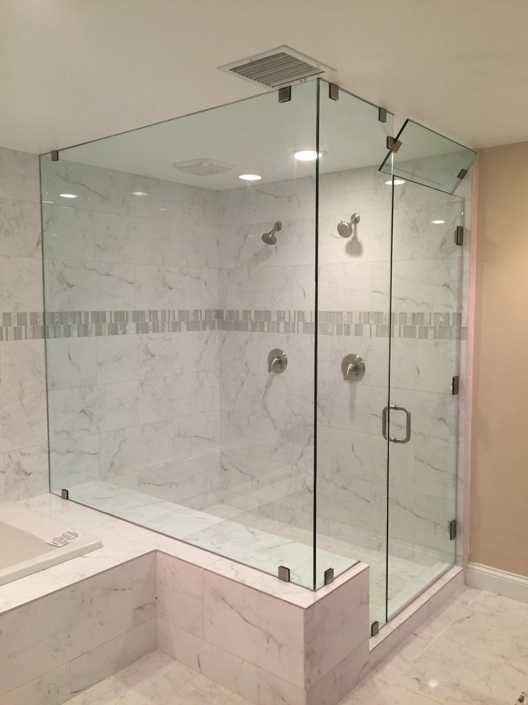 Inspiration for a transitional gray tile and white tile drop-in bathtub remodel in Orange County