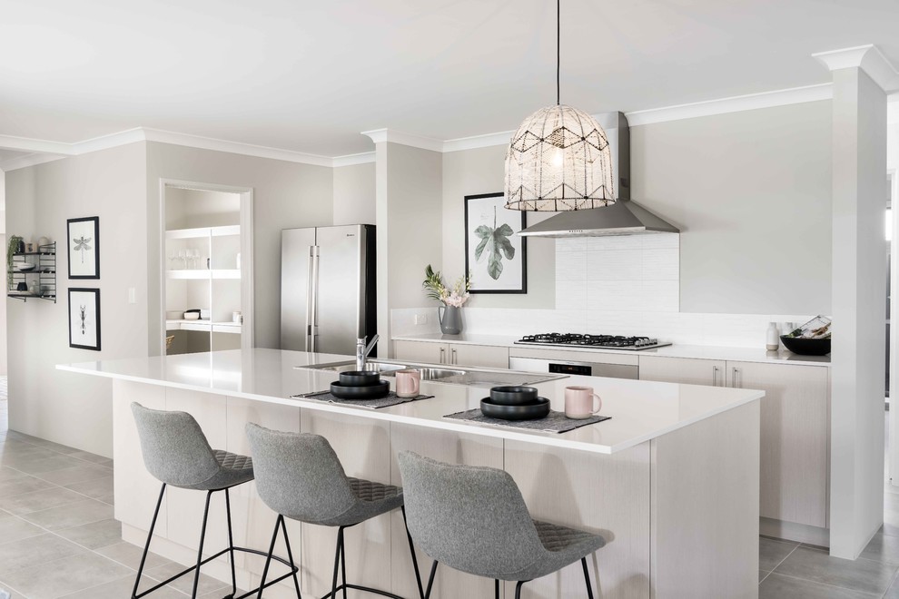 Photo of a mid-sized contemporary galley open plan kitchen in Perth with a double-bowl sink, flat-panel cabinets, beige cabinets, white splashback, stainless steel appliances, with island, grey floor, quartz benchtops, ceramic splashback and ceramic floors.