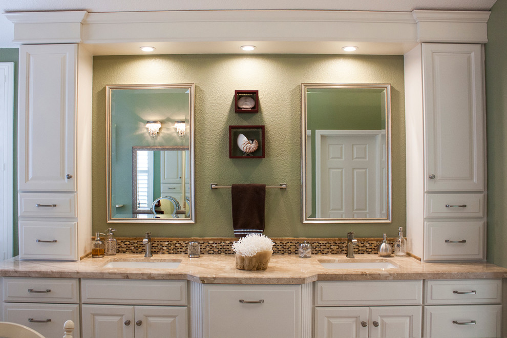 Drop-in bathtub - large transitional master multicolored tile and mosaic tile travertine floor drop-in bathtub idea with raised-panel cabinets, white cabinets, a one-piece toilet, green walls, an undermount sink and marble countertops