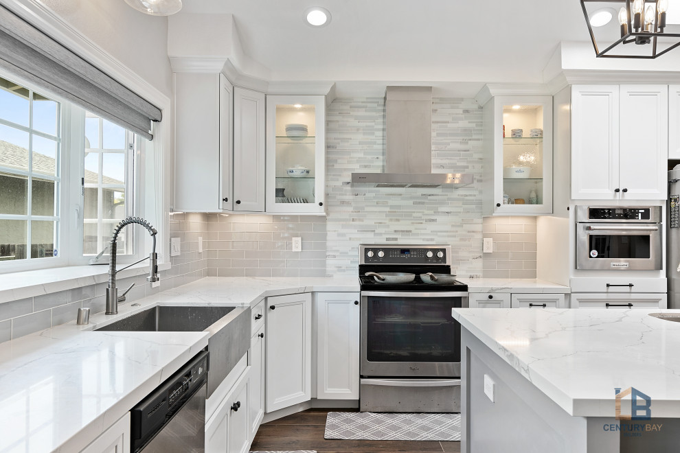 Design ideas for a traditional l-shaped eat-in kitchen in San Francisco with an undermount sink, raised-panel cabinets, white cabinets, quartz benchtops, grey splashback, porcelain splashback, stainless steel appliances, porcelain floors, with island, multi-coloured floor and white benchtop.