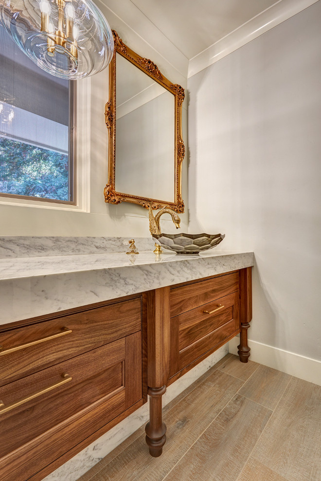 Photo of a large traditional powder room in Sacramento with beaded inset cabinets, medium wood cabinets, medium hardwood floors, a vessel sink, engineered quartz benchtops, multi-coloured floor, multi-coloured benchtops and a built-in vanity.