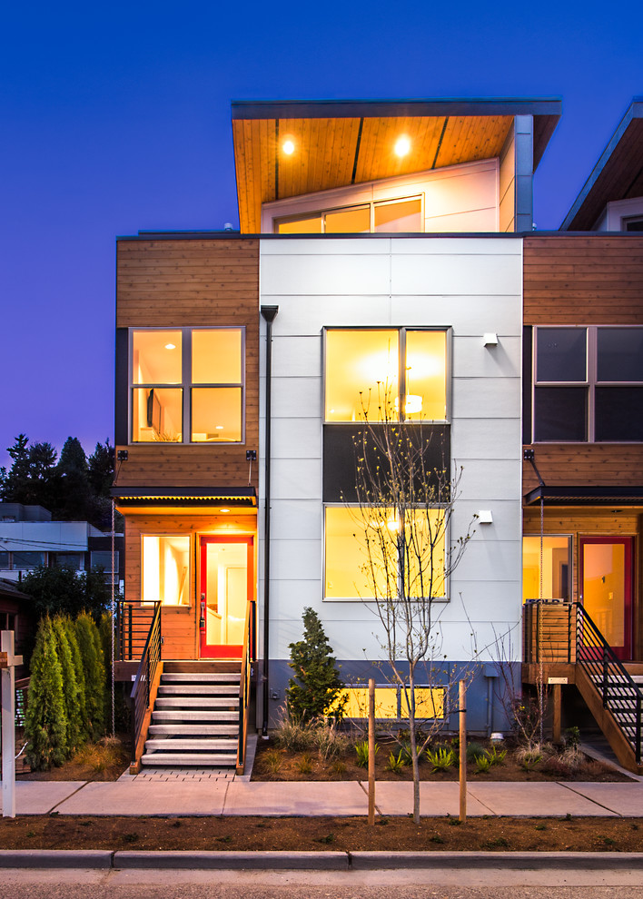 Inspiration for a contemporary three-storey townhouse exterior in Seattle with mixed siding.