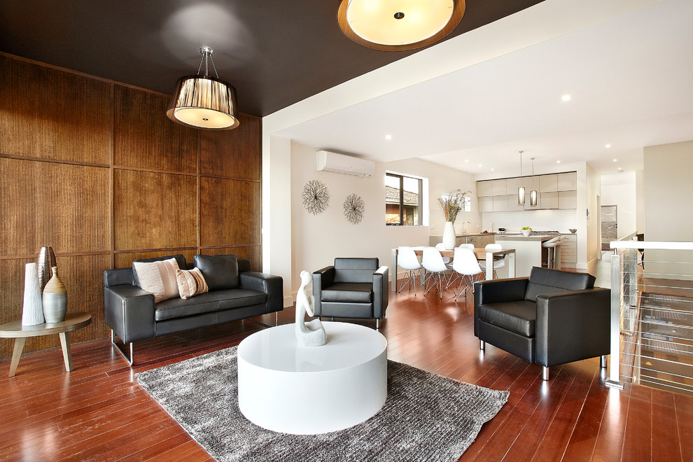 Contemporary open concept living room in Melbourne with white walls.