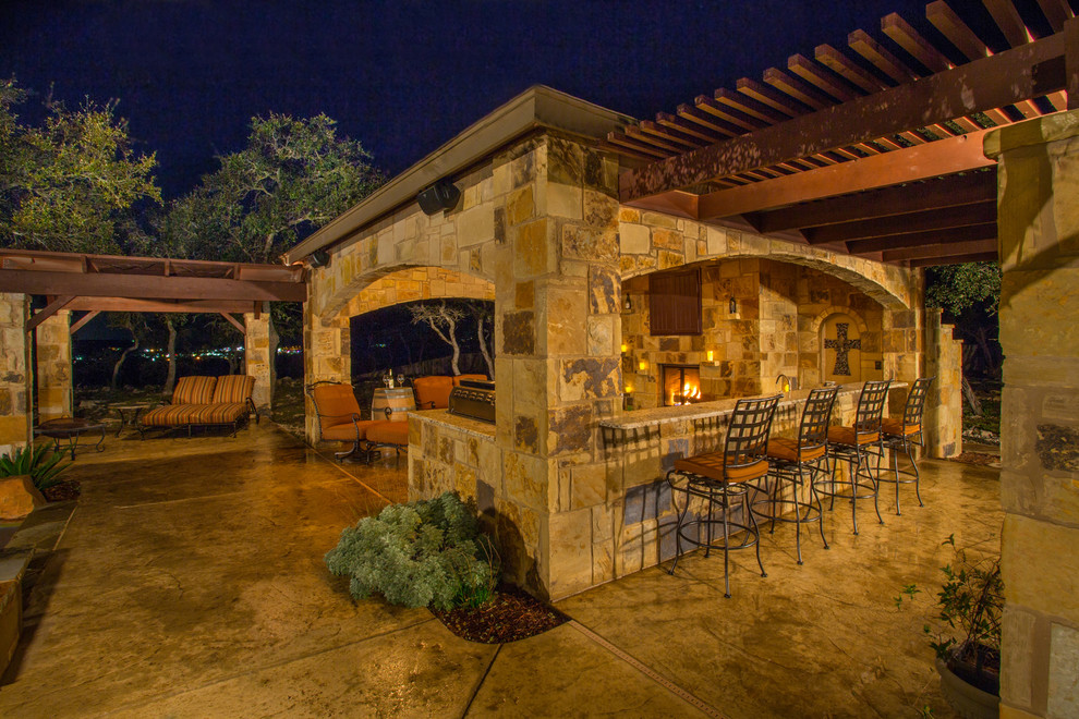 Inspiration for a mediterranean backyard patio in Austin with a fire feature, concrete slab and a gazebo/cabana.