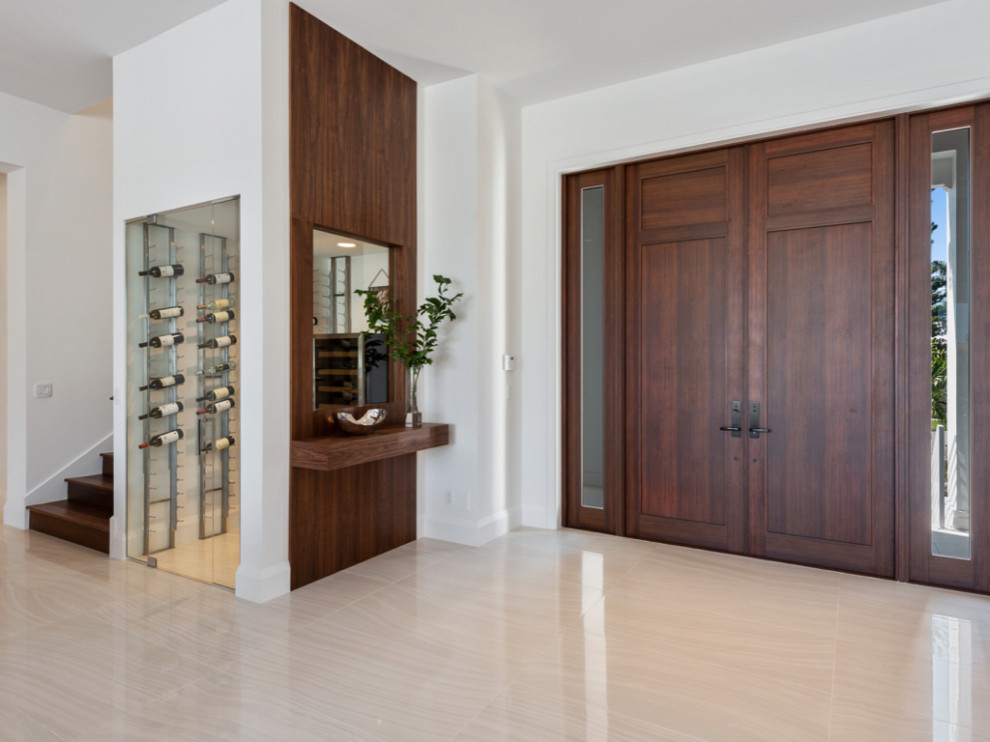 Photo of a contemporary entryway in Miami with porcelain floors, a double front door and a metal front door.