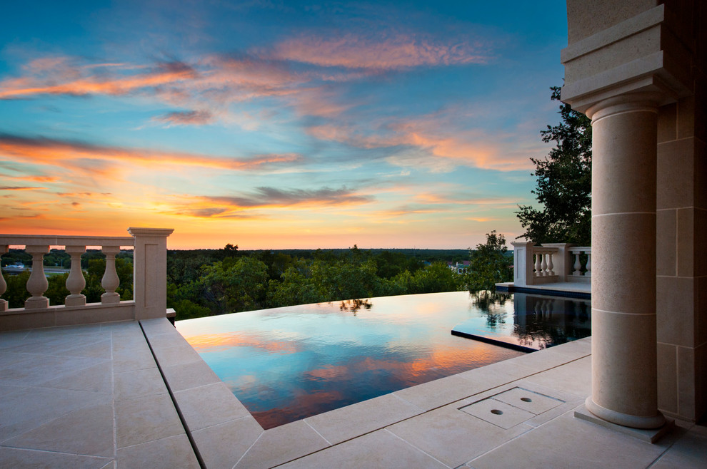 This is an example of a small traditional rectangular lap pool in Dallas with natural stone pavers and a hot tub.