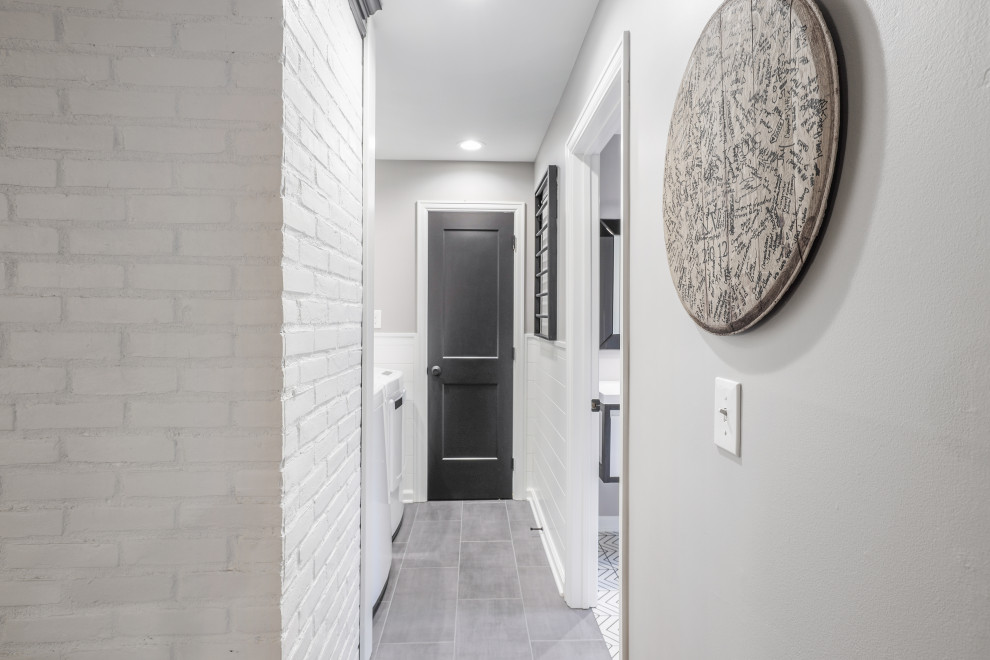 Inspiration for a small transitional single-wall dedicated laundry room in Columbus with shiplap splashback, grey walls, porcelain floors, a side-by-side washer and dryer, grey floor and planked wall panelling.