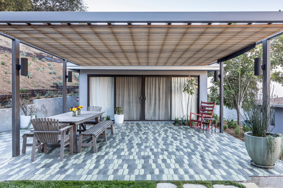 Photo of a mid-sized country backyard patio in Los Angeles with tile and a pergola.