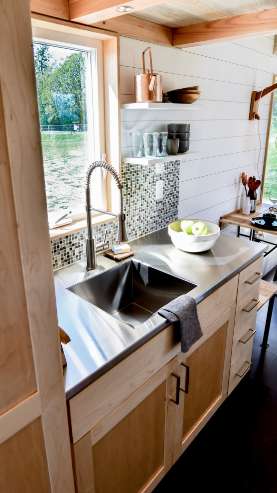 Design ideas for a small country galley open plan kitchen in Other with an integrated sink, shaker cabinets, light wood cabinets, stainless steel benchtops, green splashback, mosaic tile splashback, cork floors, no island, black floor, grey benchtop and wood.