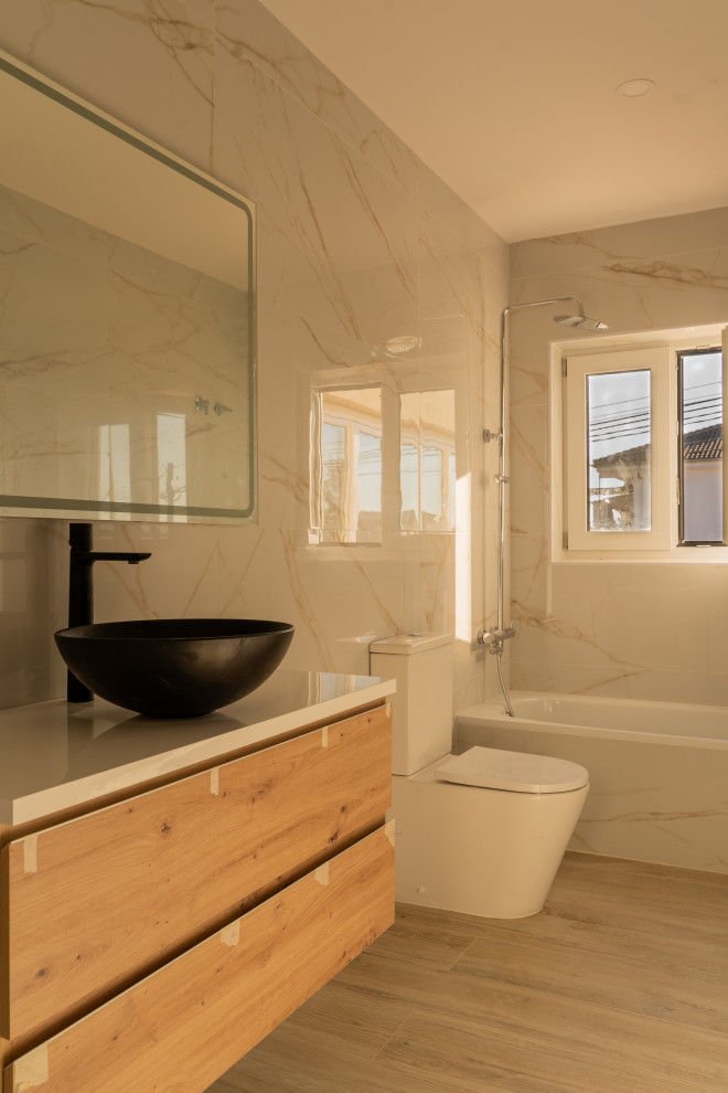 Inspiration for a mid-sized contemporary master bathroom in Barcelona with light wood cabinets, a drop-in tub, an alcove shower, white tile, marble, white walls, marble benchtops, brown floor, an open shower, white benchtops, an enclosed toilet, a single vanity, a built-in vanity and flat-panel cabinets.
