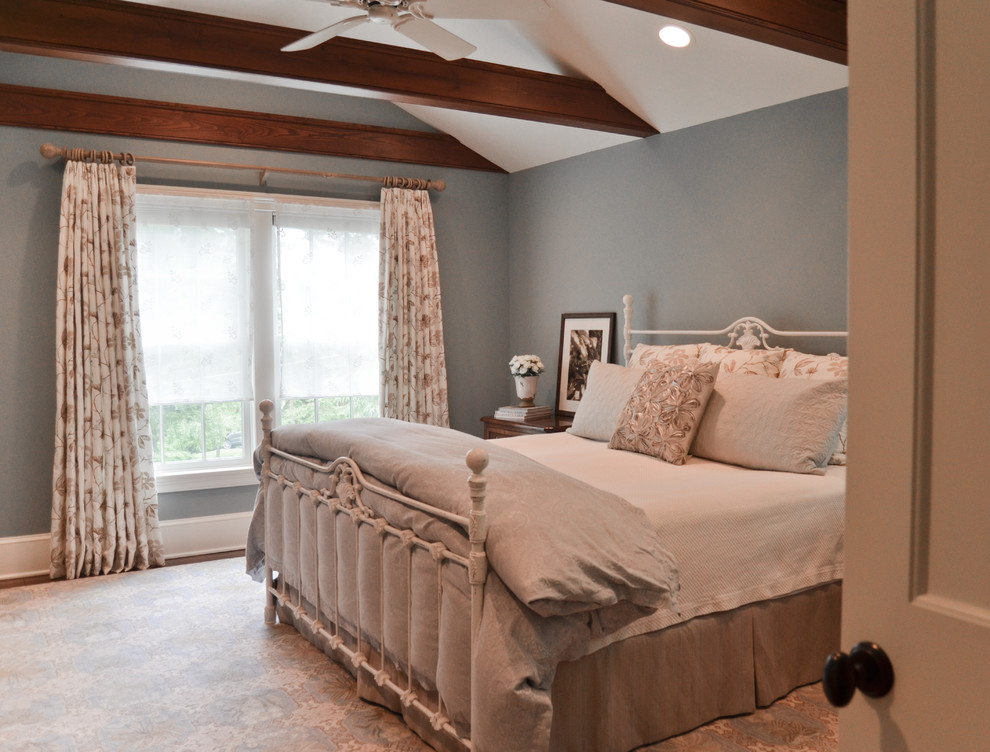 This is an example of a mid-sized traditional master bedroom in New York with blue walls and medium hardwood floors.
