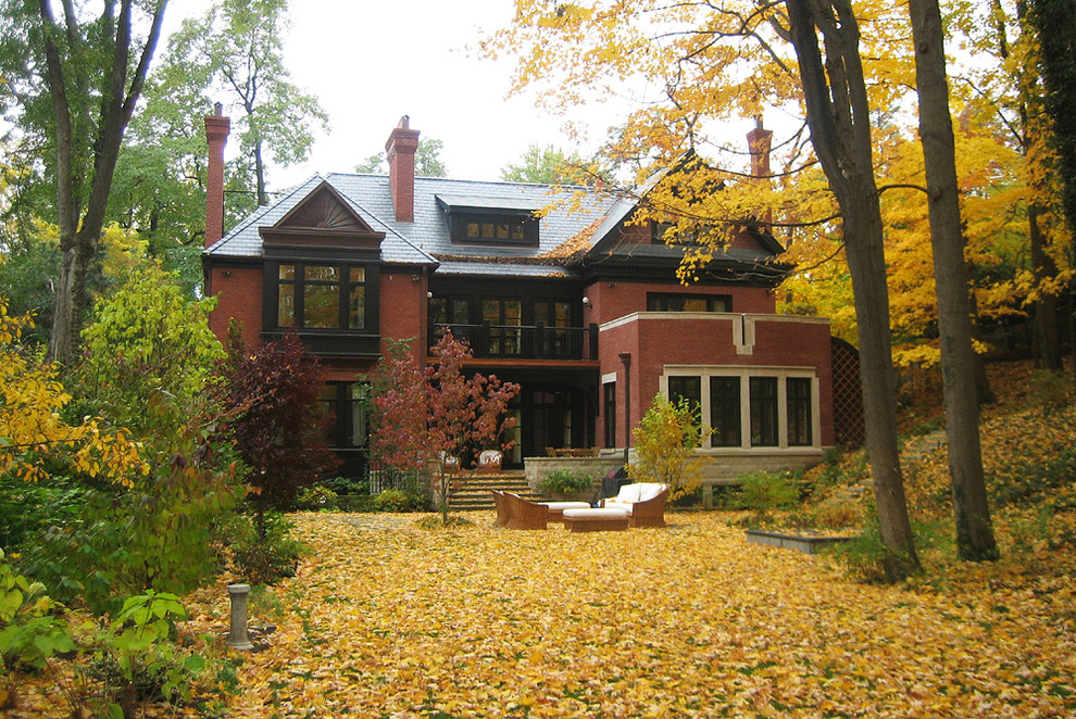 This is an example of a large eclectic three-storey brick red exterior in Toronto with a hip roof.