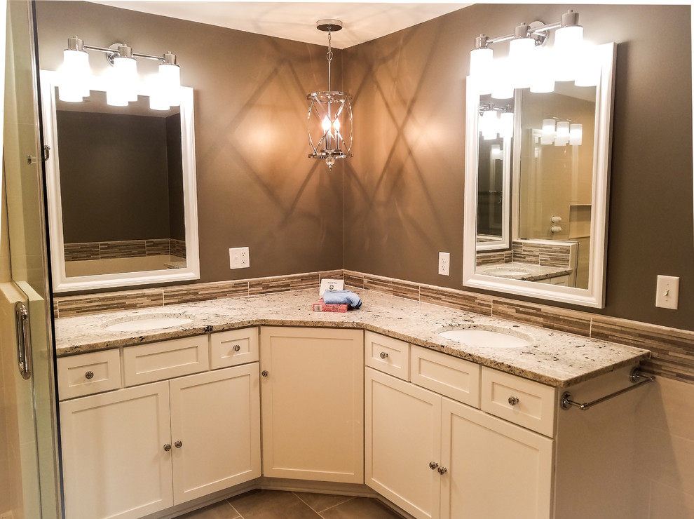 Example of a large transitional master multicolored tile and ceramic tile porcelain tile and gray floor freestanding bathtub design with shaker cabinets, white cabinets, a two-piece toilet, gray walls, an undermount sink, granite countertops and a hinged shower door