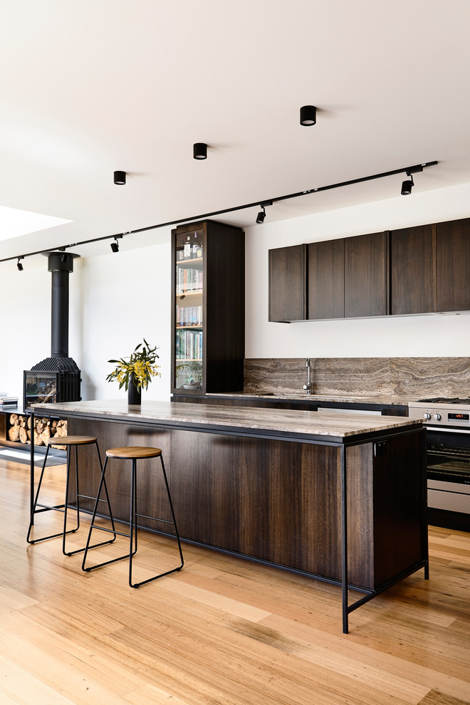 Design ideas for a mid-sized contemporary galley open plan kitchen in Other with a double-bowl sink, dark wood cabinets, marble benchtops, brown splashback, travertine splashback, stainless steel appliances, light hardwood floors, with island and brown benchtop.