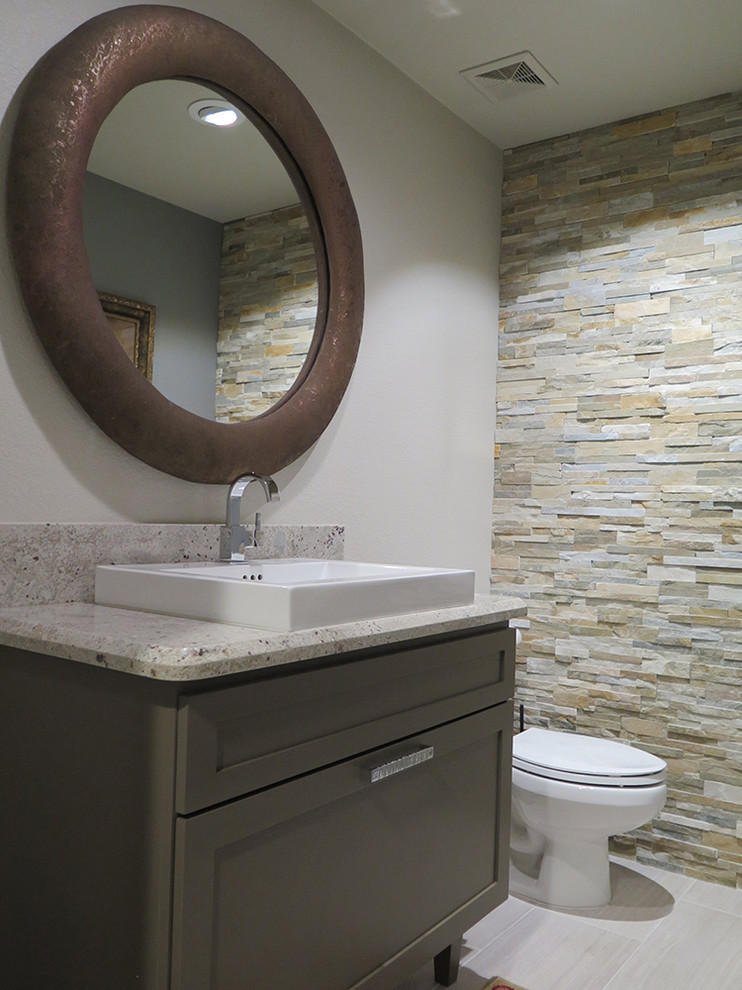 Inspiration for a small contemporary powder room in Phoenix with shaker cabinets, brown cabinets, multi-coloured tile, stone tile, a vessel sink, grey walls and porcelain floors.