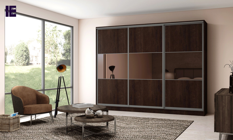 This is an example of a large modern standard wardrobe in London with glass-front cabinets and brown cabinets.