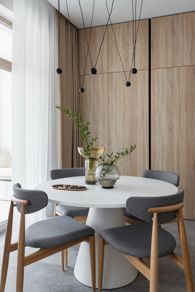 На фото: кухня-столовая среднего размера в современном стиле с полом из керамогранита, серым полом и панелями на стенах без камина
