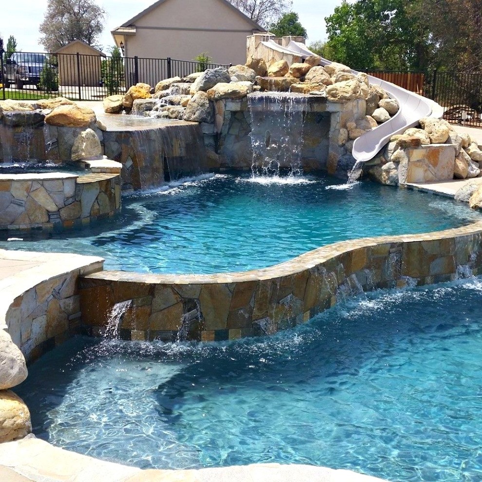 Example of a large mountain style backyard custom-shaped and concrete natural water slide design in Sacramento