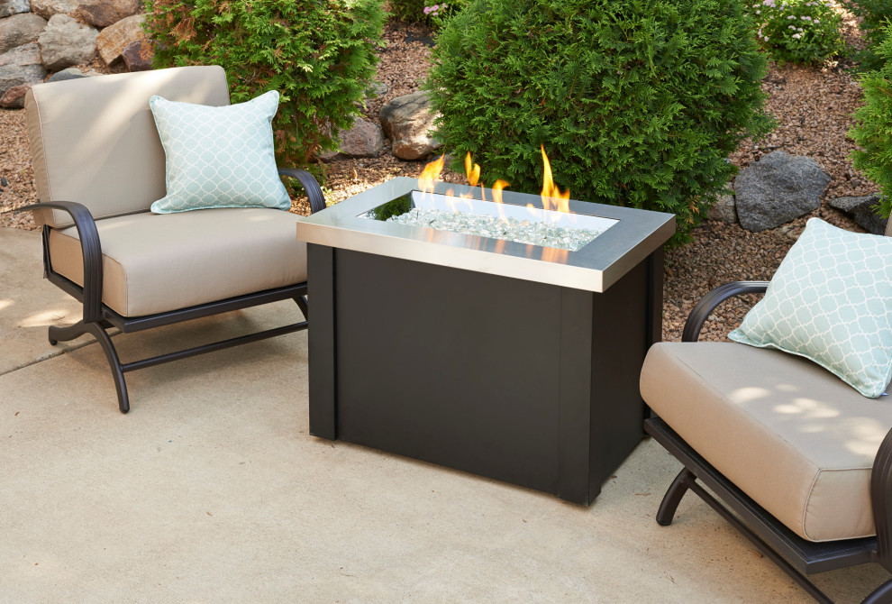 Example of a small urban backyard patio design in Minneapolis with a fire pit