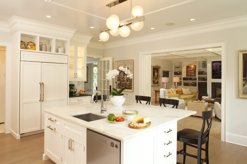 Photo of a large transitional u-shaped separate kitchen in New York with an undermount sink, recessed-panel cabinets, white cabinets, marble benchtops and with island.