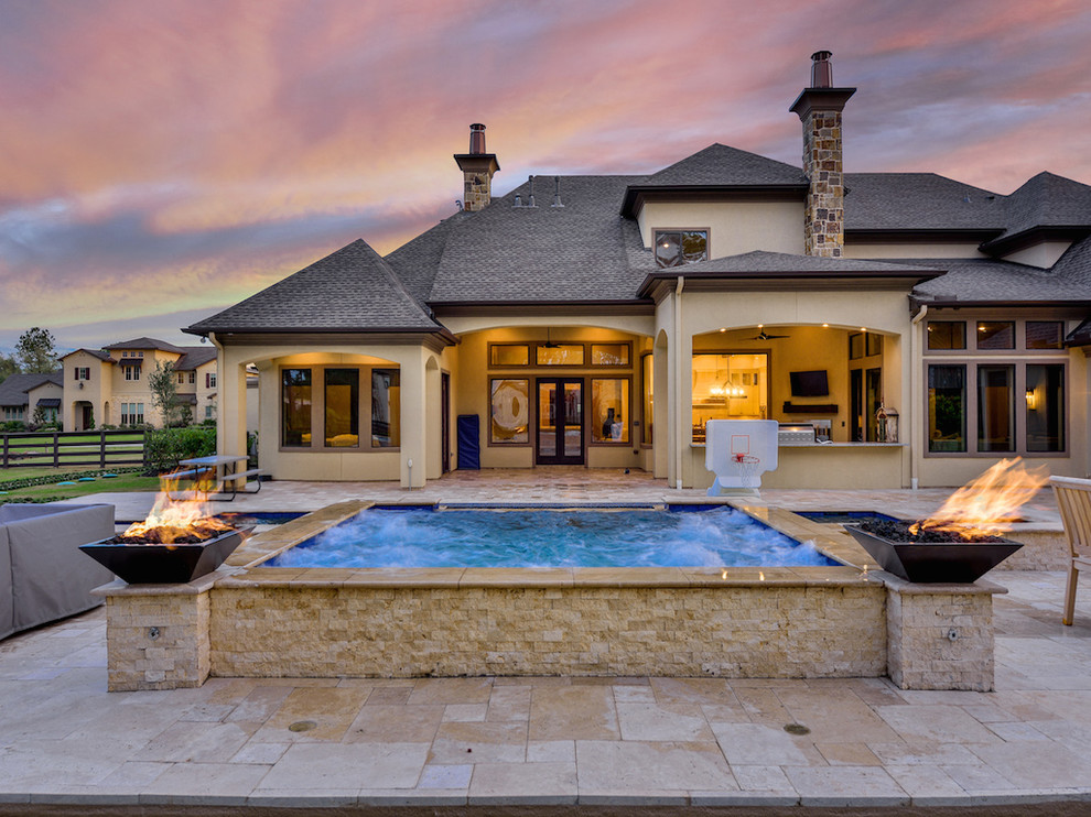 Large transitional backyard stone and rectangular natural hot tub photo in Houston