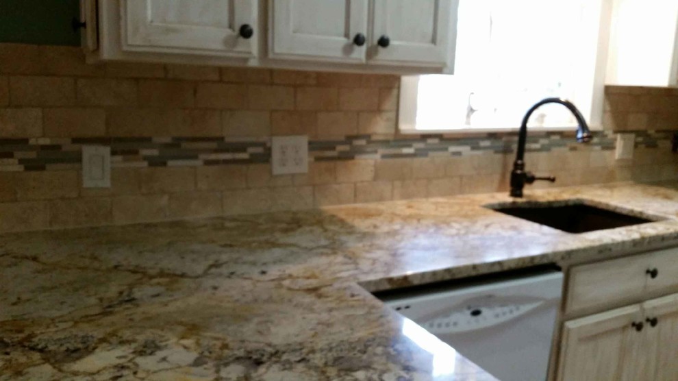 Eat-in kitchen - mid-sized transitional u-shaped eat-in kitchen idea in Seattle with an undermount sink, recessed-panel cabinets, distressed cabinets, granite countertops, beige backsplash, stone tile backsplash, white appliances and a peninsula
