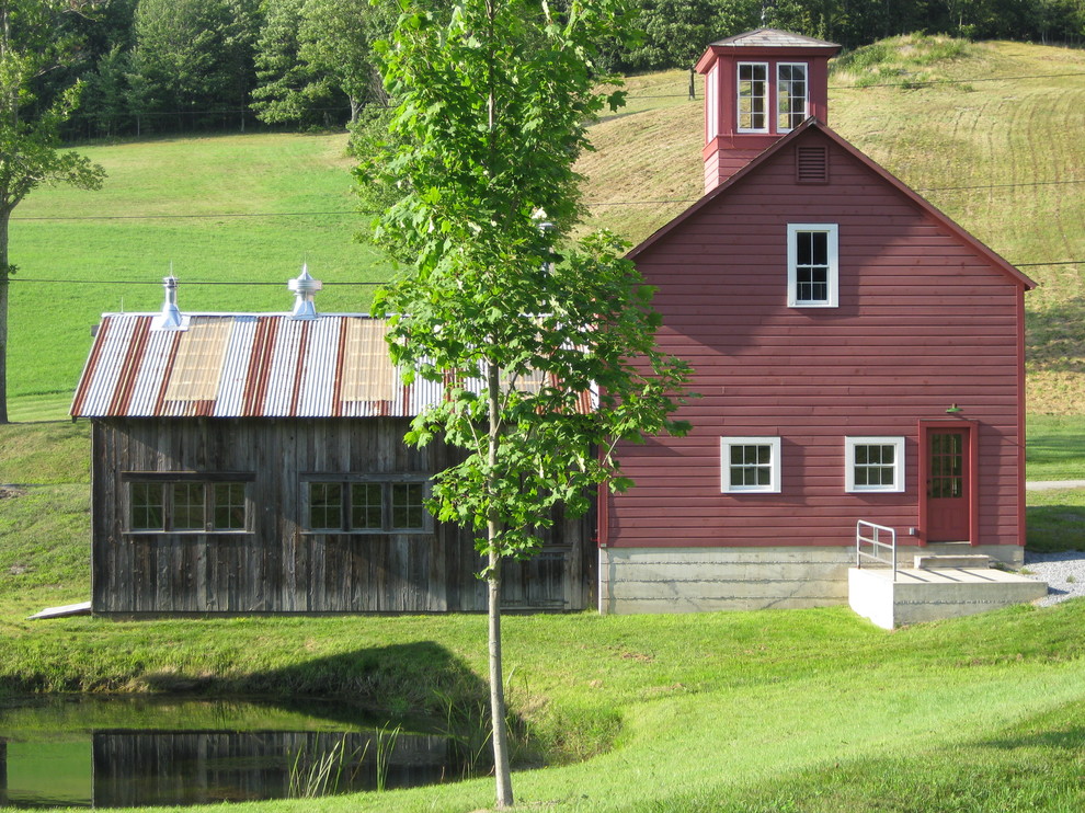 Inspiration for a country two-storey red exterior in New York with a gable roof.