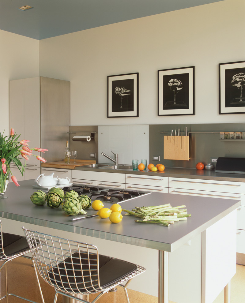 Photo of a mid-sized contemporary eat-in kitchen in San Francisco with a double-bowl sink, flat-panel cabinets, laminate benchtops, stainless steel appliances, with island and grey benchtop.