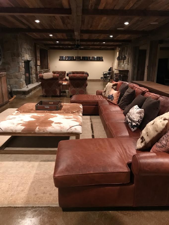 Inspiration for a large country fully buried basement in Minneapolis with beige walls, concrete floors, no fireplace and brown floor.