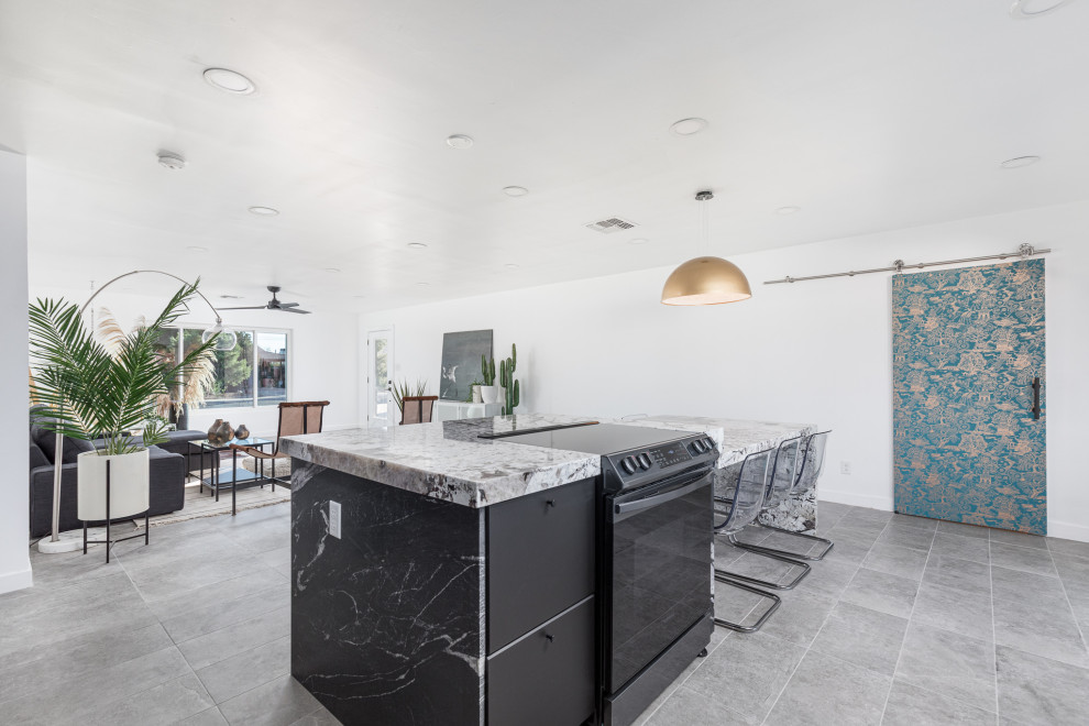 Example of a kitchen design in Phoenix with flat-panel cabinets, black cabinets and an island