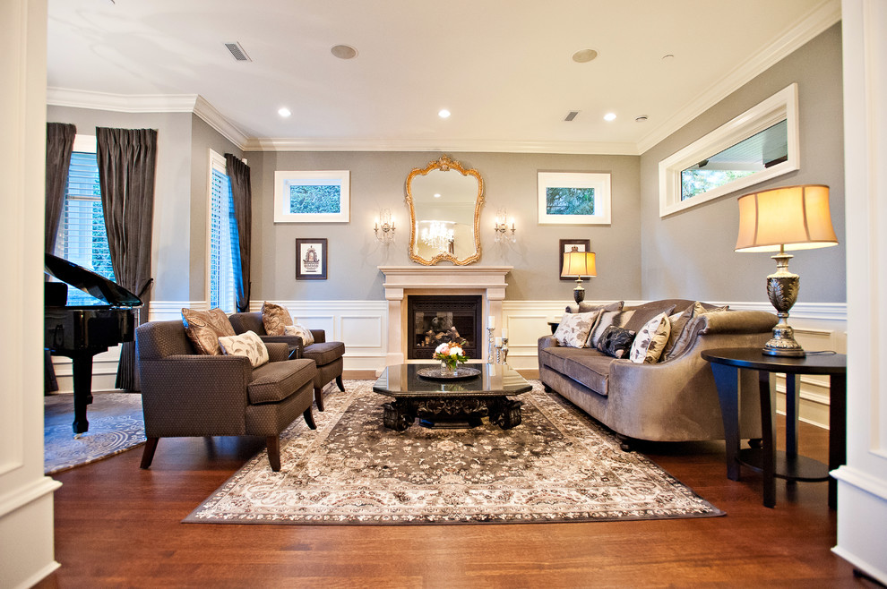 Photo of a large traditional enclosed living room in Vancouver with a music area, dark hardwood floors, a standard fireplace, grey walls, a stone fireplace surround, no tv and brown floor.
