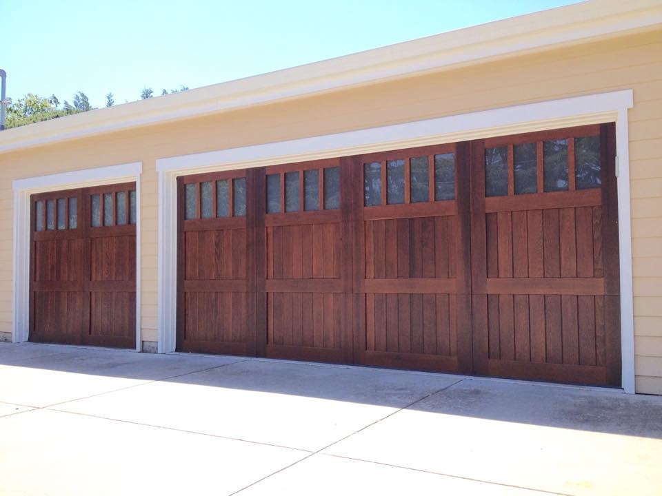 Photo of a mid-sized traditional attached three-car garage in San Francisco.