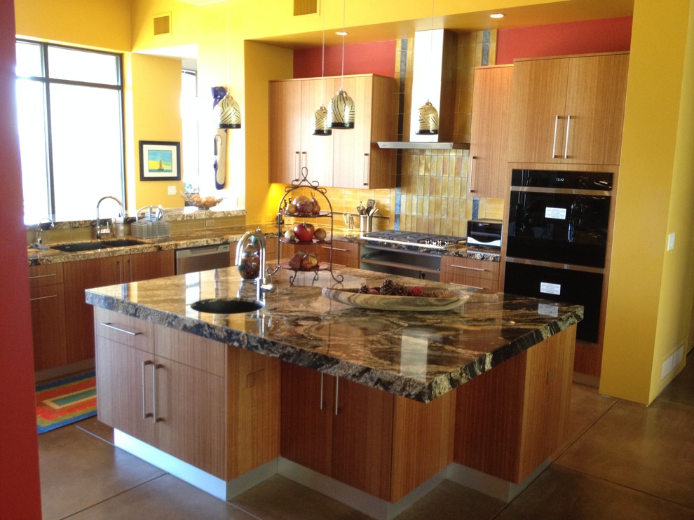 Eat-in kitchen - mid-sized transitional concrete floor eat-in kitchen idea in Phoenix with an undermount sink, flat-panel cabinets, medium tone wood cabinets, granite countertops, yellow backsplash and an island
