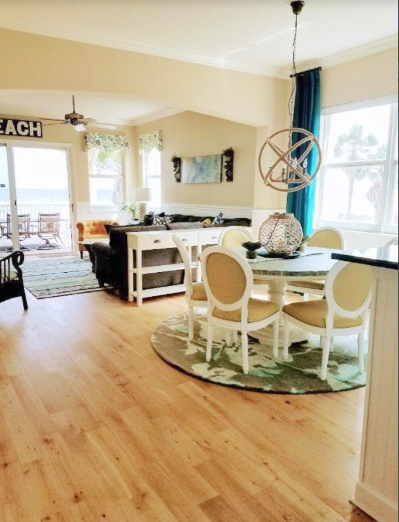 Beach style dining room in Atlanta with beige walls, light hardwood floors and no fireplace.