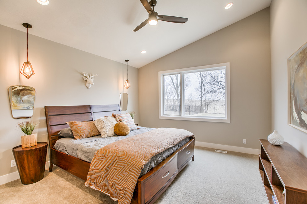 This is an example of a scandinavian master bedroom in Omaha with carpet.