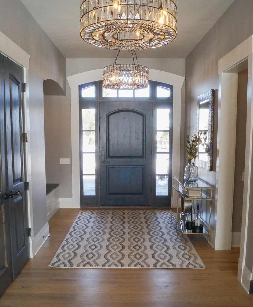 Design ideas for a mid-sized transitional foyer in Other with beige walls, light hardwood floors, a single front door, a dark wood front door and brown floor.