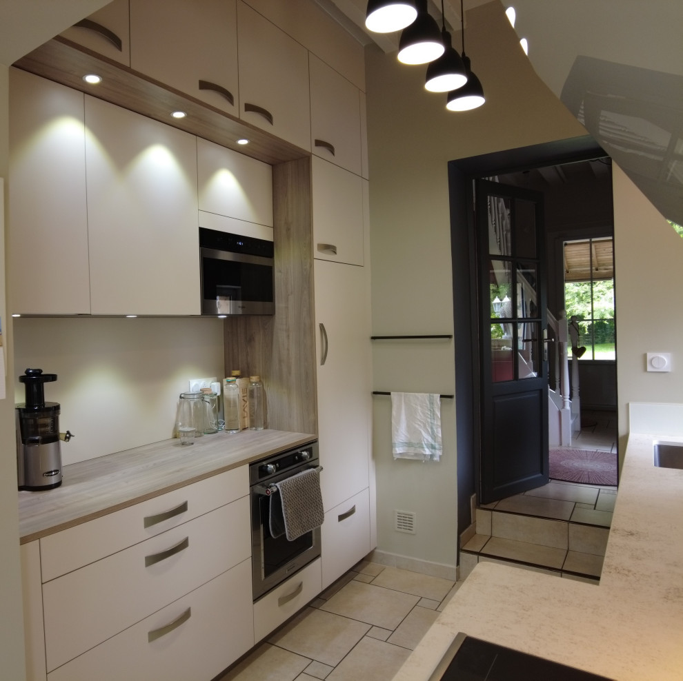 Inspiration for a mid-sized contemporary galley open plan kitchen in Other with a single-bowl sink, white splashback, glass tile splashback, white appliances, ceramic floors, beige floor, white benchtop and exposed beam.