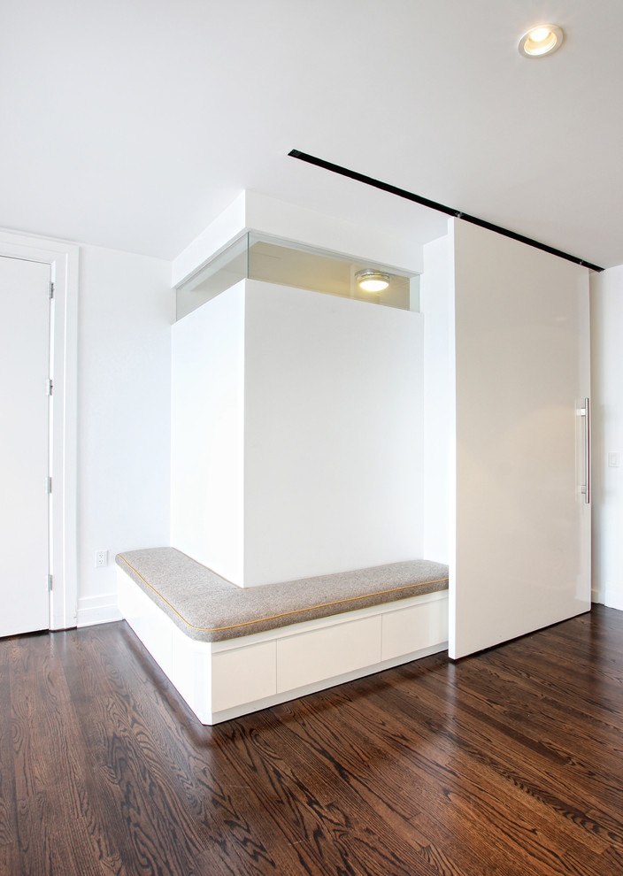 Mid-sized contemporary hallway in New York with white walls and dark hardwood floors.