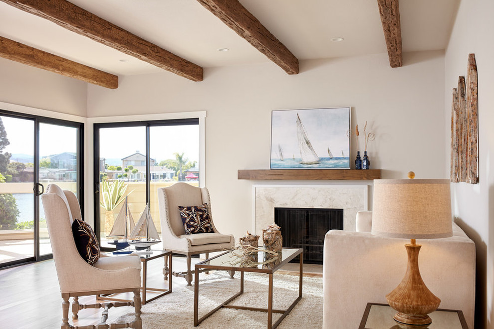 Inspiration for a mid-sized beach style open concept living room in San Francisco with a standard fireplace, grey walls, light hardwood floors, a tile fireplace surround and beige floor.