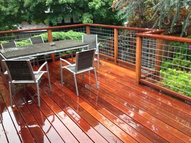 Large eclectic backyard deck in Portland with no cover.