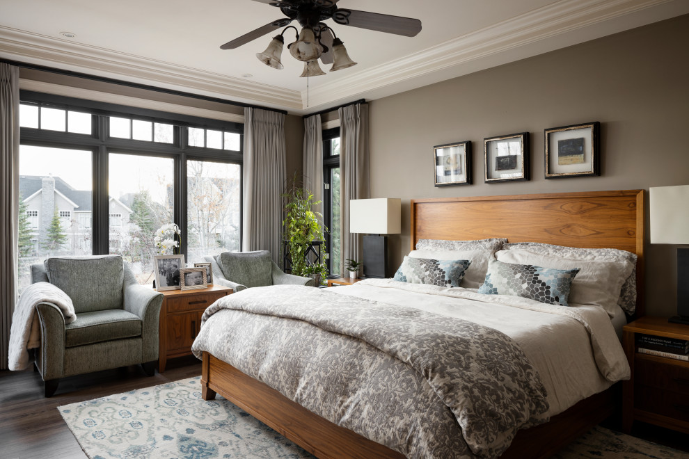 This is an example of a transitional master bedroom in Calgary with brown walls, medium hardwood floors, brown floor and coffered.